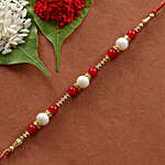 Arrangement Of Red & White Blooms With Meenakari Rakhi