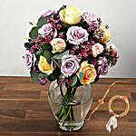 Mixed Rose And Wax Flower Arrangement In Glass Vase With Rakhi