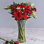 Mix Of Red Flowers In A Glass Vase
