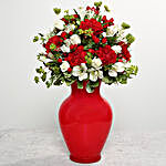 Red Carnations In Red Glass Vase
