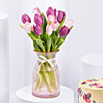Purple and Pink Tulips in Glass Vase With Cake